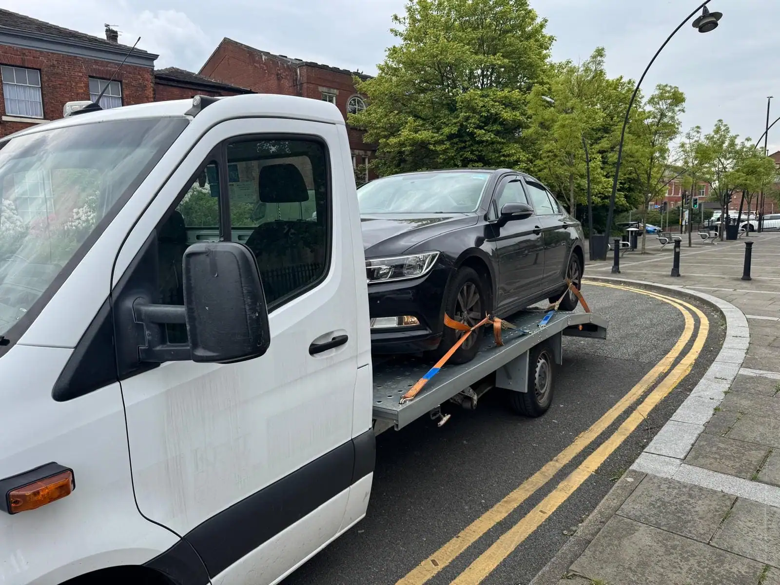 NSY Vehicle Recovery flatbed loading a customer's car on a Sheffield street